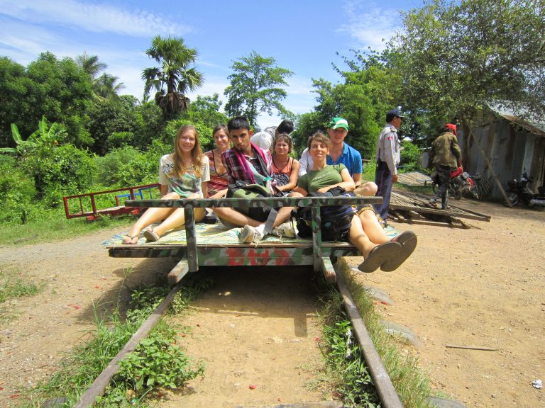 The 'train' is actually a 'norry', a weird platform that runs along the old colonial railroad tracks. I don't think this is still extant according to Wiki: https://en.wikipedia.org/wiki/Norry