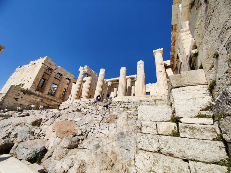 The Acropolis is often closed during summer daytimes due to the blazing heat, so the earliest we were able to get in was are. Here's my first contact with the legendary site. By the Beaulé Gate and underneath the Temple of Athena Nike, I think.
